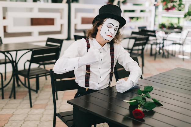 Angry mime sitting in a terrace