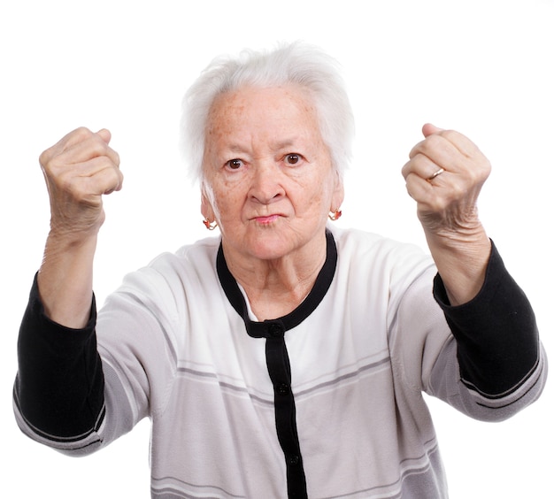 Angry old woman making fists isolated