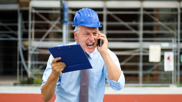 Angry senior engineer shouting at the phone