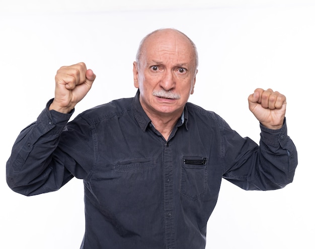 Angry senior man posing in studio