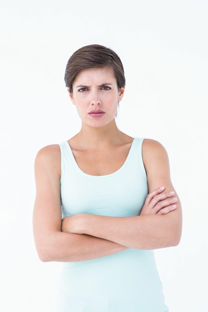 Angry woman looking at camera with arms crossed 