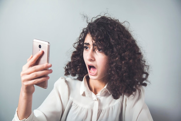 Angry woman talking in smart phone