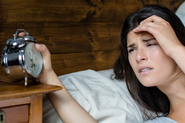 Angry woman with alarm clock