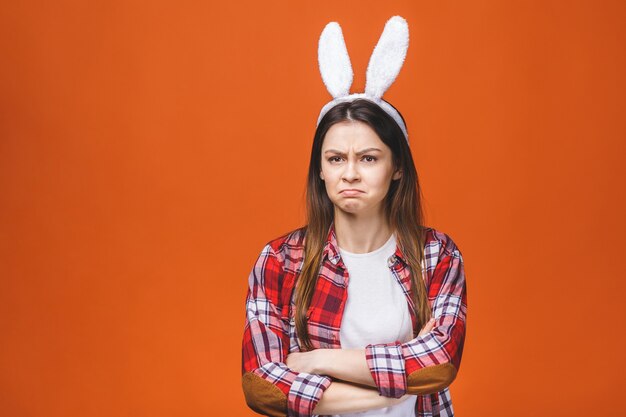 Angry young caucasian woman in bunny ears