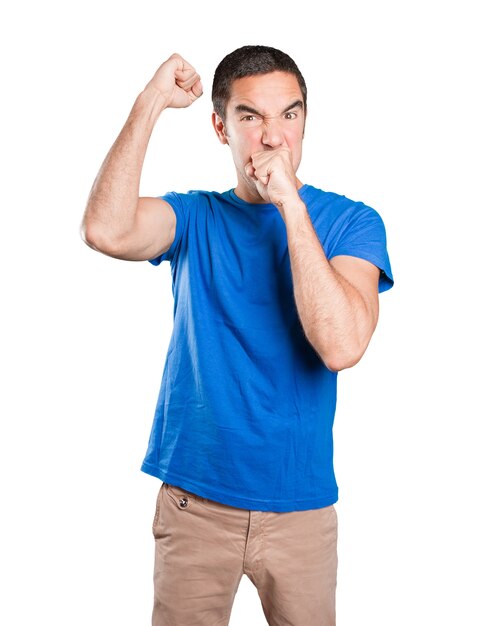 Angry young man against white background