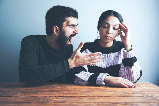 Angry young man arguing with sad  woman
