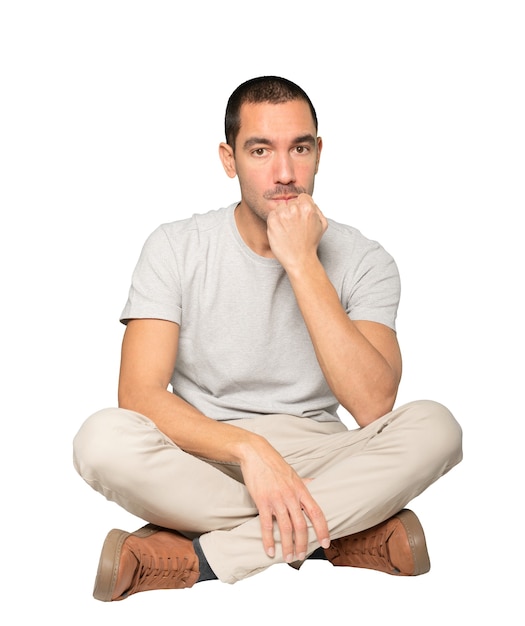 Angry young man posing against background