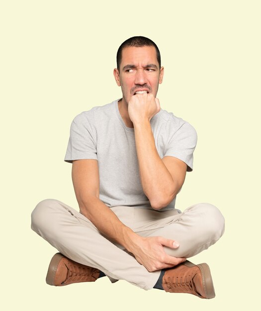 Angry young man posing against background