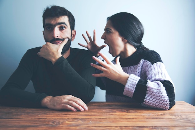 Angry young woman arguing with man