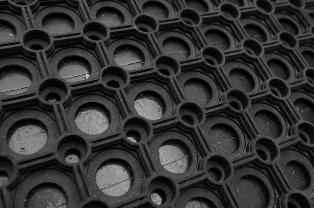 An angular view of a black rubber door mat