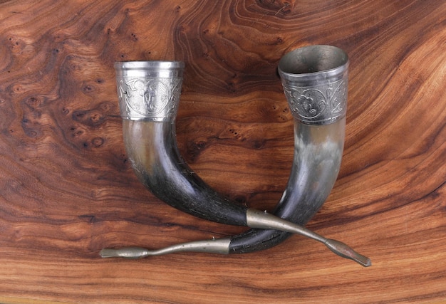 animal horn for wine on wooden background