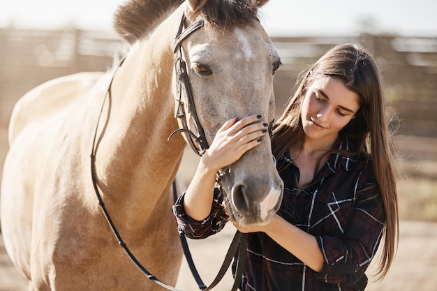 Animals friendship and hobby concept Pretty young woman in rur