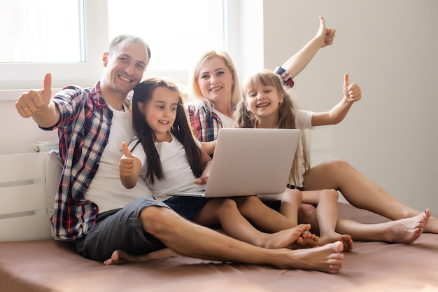 Animated family buying online lying down on bed at home