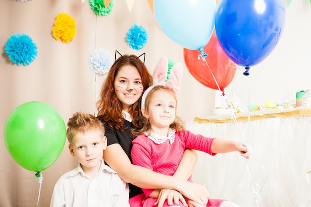 Animator with wonderful children are playing with baloons