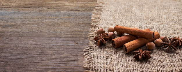 Anise star and cinnamon sticks on wooden table