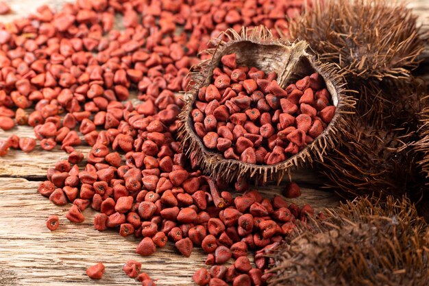 Annatto seeds on rustic wood