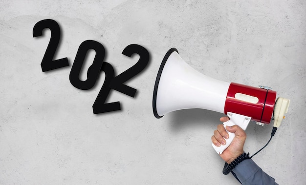 Announcement of the 2022 business plan closeup hand of a businessman holding a megaphone