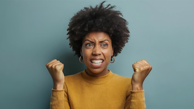 Photo annoyed african american woman clenches teeth and fists being peevish