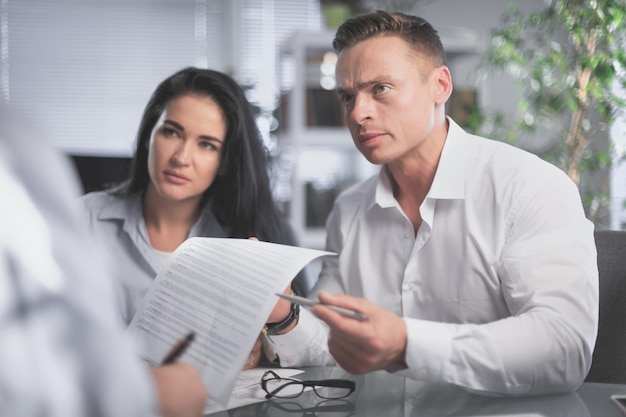 Annoyed disappointed customers clients couple holding paper complain on bad contract