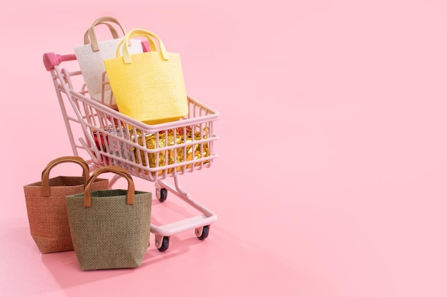 Annual sale shopping season concept mini pink shop cart trolley full of paper bag gift isolated on pale pink background blank copy space close up