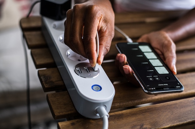 Anonymous African American person putting charging USB