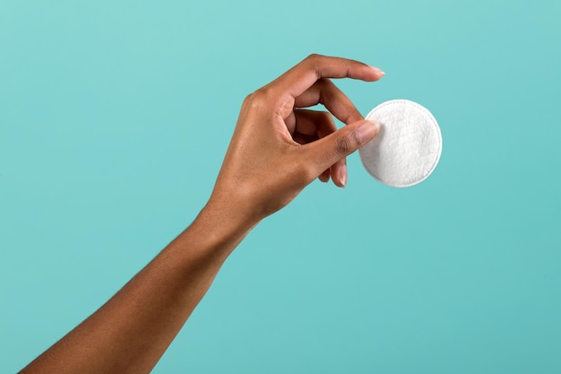 Anonymous African American woman showing cotton pad