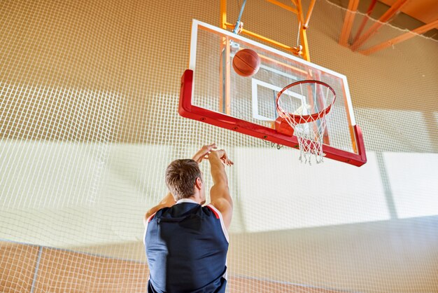 Anonymous basketball player throwing ball