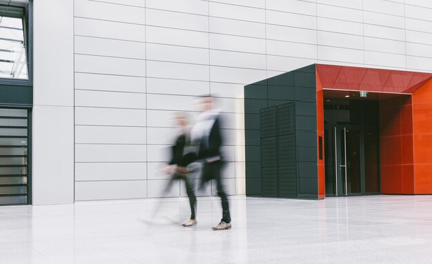 Anonymous Blurred Business People In A Modern Floor