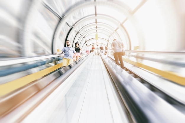 Anonymous commuter rushing on a escalator