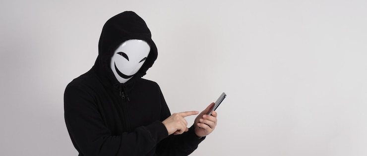 Photo anonymous hacker and face mask with smartphone in hand