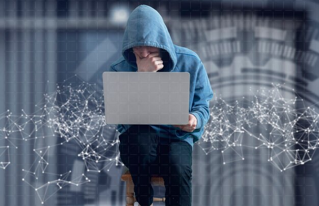 A anonymous hacker person in the hood with computer, digital information breaking