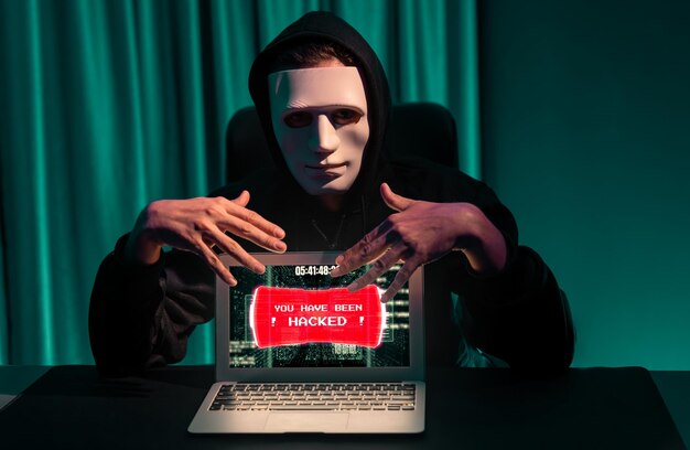 Photo anonymous mask successful making password encryption hack on laptop pecuniary