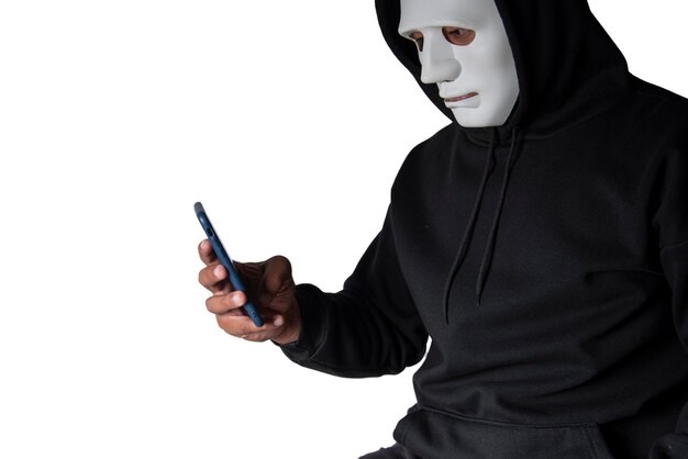 Anonymous masked hacker is using smartphones to penetrate financial data with clipping path hacking and malware concept