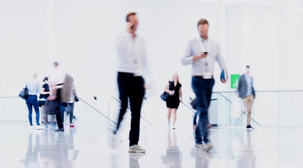 Anonymous people go through hall in business office