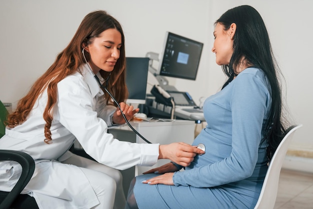 Photo another consultation pregnant woman is in the clinic in cabinet and have health check