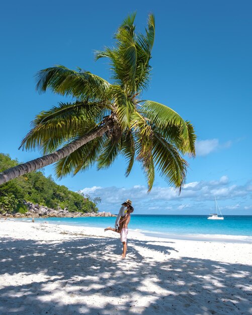 Anse georgette praslin seychelles young couple of men and woman on a tropical beach during a luxury vacation in seychelles tropical beach anse georgette praslin seychelles