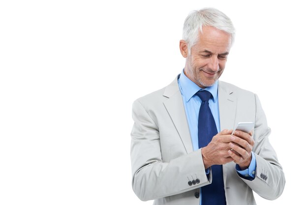 Answering a quick text Studio shot of a mature businessman using a cellphone isolated on white