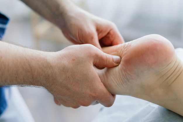 Anti-cellulite foot massage for a fat woman. Concept of personal care, weight loss, diet. Close-up.