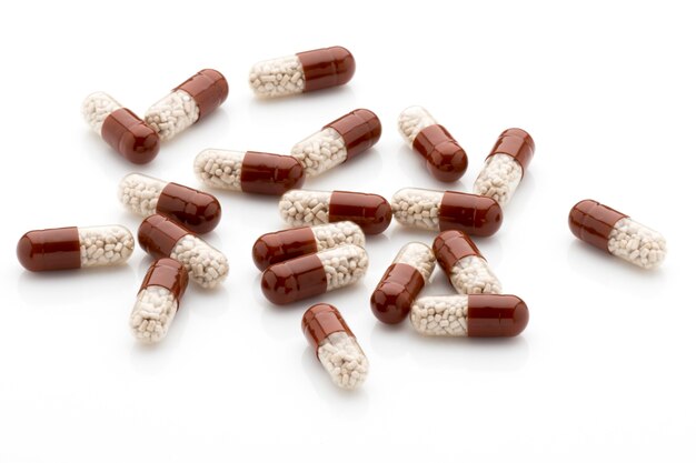 Antibiotic capsules on a white background.