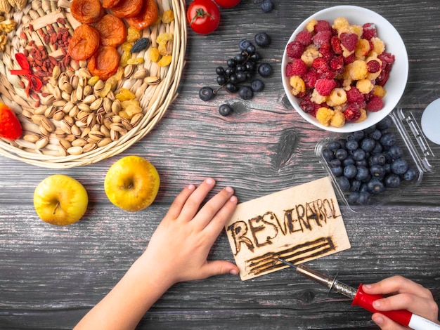 Antioxidants resveratrol food with text RESVERATROL on wooden surface