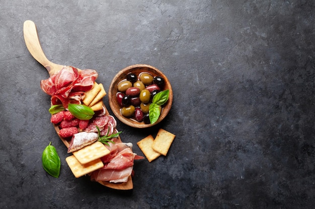 Antipasto board with prosciutto salami crackers olives