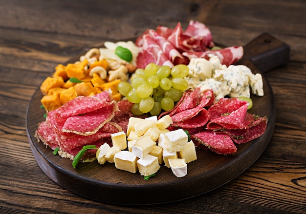 Antipasto catering platter with bacon, jerky, sausage, blue cheese and grapes