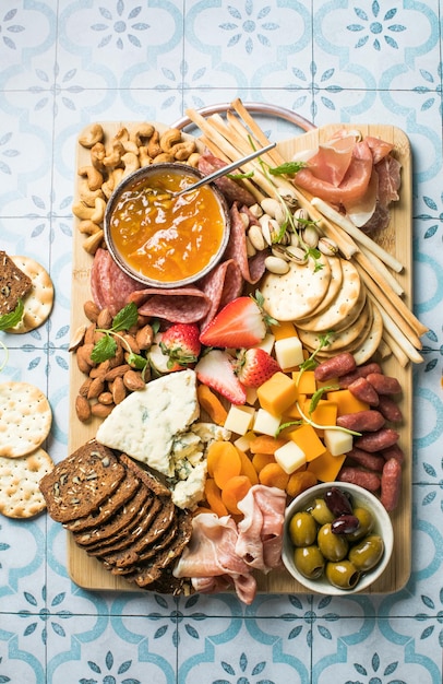 Antipasto meat board catering platter with jamon sausage and cheese Food recipe background Close up