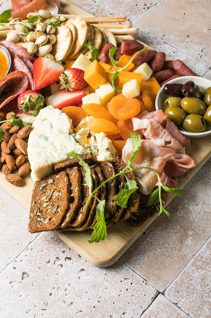 Antipasto meat board catering platter with jamon sausage and cheese Food recipe background Close up