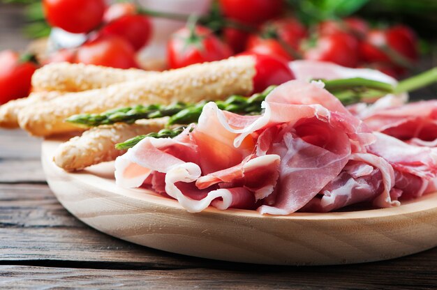 Antipasto with ham and green asparagus