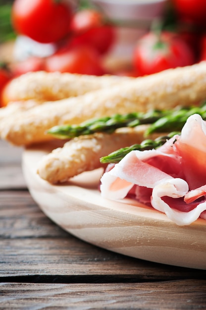 Antipasto with ham and green asparagus