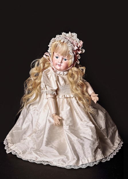 Antique blond doll on a brown background