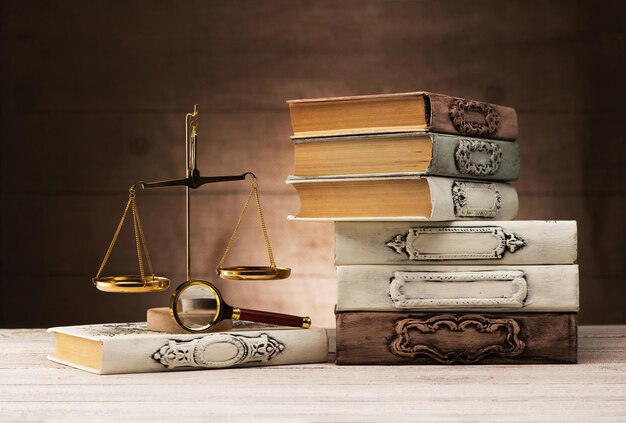 Antique books, magnifying glass and scales. justice concept