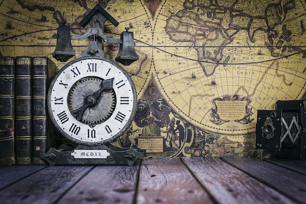 antique books with camera and clock