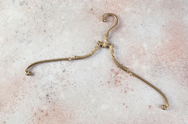 Antique brass clothes hanger